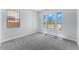 Well-lit bedroom showcasing large windows and plush carpeting for comfort at 21539 S 191St Pl, Queen Creek, AZ 85140