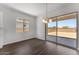 Bright dining area with tile floors, pendant lighting, and sliding glass doors leading to outdoor space at 21539 S 191St Pl, Queen Creek, AZ 85140