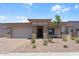 Charming single-story home with stone accents, low maintenance desert landscaping, and a two car garage at 21539 S 191St Pl, Queen Creek, AZ 85140