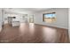 Bright, open living space with sleek tile flooring, modern kitchen, and large windows for natural light at 21539 S 191St Pl, Queen Creek, AZ 85140