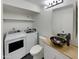 Well-lit bathroom with modern vessel sink, stylish mirror, and new washer and dryer at 2155 W Farmdale Ave # 24, Mesa, AZ 85202