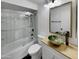Modern bathroom with unique sink, stylish mirror, and tiled shower with glass door at 2155 W Farmdale Ave # 24, Mesa, AZ 85202