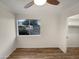 Bedroom featuring wood floors and a window with views of the outdoor landscaping at 2155 W Farmdale Ave # 24, Mesa, AZ 85202
