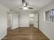 Cozy bedroom featuring wood floors, a ceiling fan and natural light from the window at 2155 W Farmdale Ave # 24, Mesa, AZ 85202