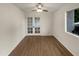 Neutral bedroom with wood floors, ceiling fan, and natural light from the window at 2155 W Farmdale Ave # 24, Mesa, AZ 85202