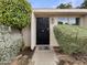 Front door with decorative iron, surrounded by lush, manicured greenery at 2155 W Farmdale Ave # 24, Mesa, AZ 85202