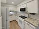 Well-lit kitchen with white cabinets, granite countertops, and modern appliances at 2155 W Farmdale Ave # 24, Mesa, AZ 85202