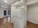 Kitchen featuring white appliances, wood floors and access to an outdoor patio at 2155 W Farmdale Ave # 24, Mesa, AZ 85202