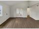 Open concept living space featuring wood floors and glass doors leading to a bedroom at 2155 W Farmdale Ave # 24, Mesa, AZ 85202