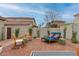 The backyard has cozy seating and lounge chair with easy to maintain desert landscaping at 21860 N 41St St, Phoenix, AZ 85050