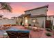 Beautiful backyard featuring a seating area, pavers and rock landscaping at sunset at 21860 N 41St St, Phoenix, AZ 85050