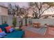 Relaxing backyard features seating with lounge chair, patio umbrella, and a colorful outdoor rug at 21860 N 41St St, Phoenix, AZ 85050
