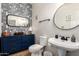 Chic powder room with unique wallpaper, a pedestal sink, and decorative mirrors at 21860 N 41St St, Phoenix, AZ 85050