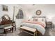 Cozy bedroom featuring a queen bed with neutral bedding and a window providing natural light and a vanity table at 21860 N 41St St, Phoenix, AZ 85050