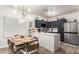 Stylish kitchen with gray cabinets, stainless steel appliances, and a dining area with modern lighting at 21860 N 41St St, Phoenix, AZ 85050