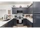 Close-up of the kitchen featuring gray cabinets, a stainless steel range, and quartz countertops at 21860 N 41St St, Phoenix, AZ 85050