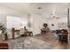 Inviting living room with a wooden desk, modern fan, and wood-look flooring at 21860 N 41St St, Phoenix, AZ 85050