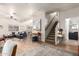 Spacious open-concept living area with comfortable seating and staircase at 21860 N 41St St, Phoenix, AZ 85050