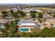 Aerial view of an estate featuring a pool, covered patio, mature trees, and mountain views in a residential community at 2251 N 32Nd St # 31, Mesa, AZ 85213