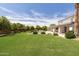 Serene backyard with a beautiful pool, mature trees, and a spacious lawn offering privacy and tranquility at 2251 N 32Nd St # 31, Mesa, AZ 85213