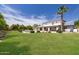 Lush backyard with a refreshing pool, open lawn space, and a covered patio for relaxation and entertainment at 2251 N 32Nd St # 31, Mesa, AZ 85213
