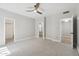 Bright bedroom boasts a ceiling fan, multiple doorways, and plush carpeting at 2251 N 32Nd St # 31, Mesa, AZ 85213