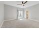 Bright bedroom with a ceiling fan, window with curtains, and doorway to a closet at 2251 N 32Nd St # 31, Mesa, AZ 85213