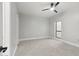 This is a neutral bedroom with a ceiling fan and view from the bright side window at 2251 N 32Nd St # 31, Mesa, AZ 85213