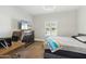 Bright bedroom featuring a ceiling fan, a television, an arm chair, and a desk at 2251 N 32Nd St # 31, Mesa, AZ 85213