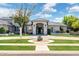 Elegant single-story home with a circular driveway, well-manicured lawn, and classic architectural details at 2251 N 32Nd St # 31, Mesa, AZ 85213