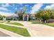Stunning single-story home featuring a circular driveway, lush landscaping, and a welcoming entryway at 2251 N 32Nd St # 31, Mesa, AZ 85213