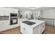 Bright kitchen island with stainless steel appliances and gray backsplash at 2251 N 32Nd St # 31, Mesa, AZ 85213
