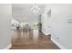 Spacious open-concept living room with wood floors and modern chandelier at 2251 N 32Nd St # 31, Mesa, AZ 85213