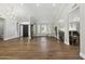Spacious living area featuring hardwood floors, a grand piano, and front door access at 2251 N 32Nd St # 31, Mesa, AZ 85213