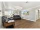 Sitting area features hardwood floors, gray sofa, and paneled windows at 2251 N 32Nd St # 31, Mesa, AZ 85213