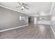 Bright living room boasts hardwood floors, white trim, neutral paint, and a modern ceiling fan at 2251 N 32Nd St # 31, Mesa, AZ 85213