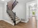 Carpeted stairs with dark wood trim lead to the upper level of the home at 2251 N 32Nd St # 31, Mesa, AZ 85213
