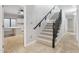 Bright interior showcasing a carpeted staircase with a dark wood banister and tile flooring at 2251 N 32Nd St # 31, Mesa, AZ 85213