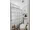 Bathroom with toilet, built-in shelves, cabinet, and a shower with a white and gray curtain at 22752 E Arroyo Verde Dr, Queen Creek, AZ 85142