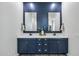 Bathroom featuring double sinks, a blue accent wall, and plank floors for easy maintenance at 22752 E Arroyo Verde Dr, Queen Creek, AZ 85142