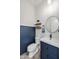 Charming bathroom with blue wainscoting, a vessel sink, and a round mirror creating a fresh and modern aesthetic at 22752 E Arroyo Verde Dr, Queen Creek, AZ 85142