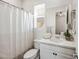 Bright bathroom with a shower featuring a white shower curtain, white vanity, and a large mirror above at 22752 E Arroyo Verde Dr, Queen Creek, AZ 85142