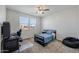 Bedroom featuring a single bed, gaming system, and large windows for natural light at 22752 E Arroyo Verde Dr, Queen Creek, AZ 85142