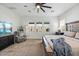 Bright bedroom featuring a ceiling fan, TV, comfy chair, and three windows with great natural light at 22752 E Arroyo Verde Dr, Queen Creek, AZ 85142