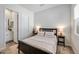 Cozy bedroom featuring a queen bed, nightstands with lamps, and an en-suite bathroom through the doorway at 22752 E Arroyo Verde Dr, Queen Creek, AZ 85142