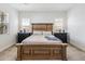 This spacious bedroom features a wooden bed frame and modern bedside tables at 22752 E Arroyo Verde Dr, Queen Creek, AZ 85142