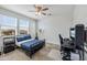 Comfortable bedroom featuring a bed, desk, and plenty of natural light from the windows at 22752 E Arroyo Verde Dr, Queen Creek, AZ 85142