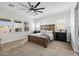 Main bedroom features a large bed frame, a ceiling fan, and two windows at 22752 E Arroyo Verde Dr, Queen Creek, AZ 85142