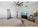 Spacious bedroom with a ceiling fan, TV, chair, and carpet flooring for maximum comfort at 22752 E Arroyo Verde Dr, Queen Creek, AZ 85142