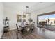 Comfortable dining area with an outdoor view, modern light fixture and wood-style flooring at 22752 E Arroyo Verde Dr, Queen Creek, AZ 85142